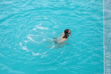 Children swimming in a pool with a diving mask clipart