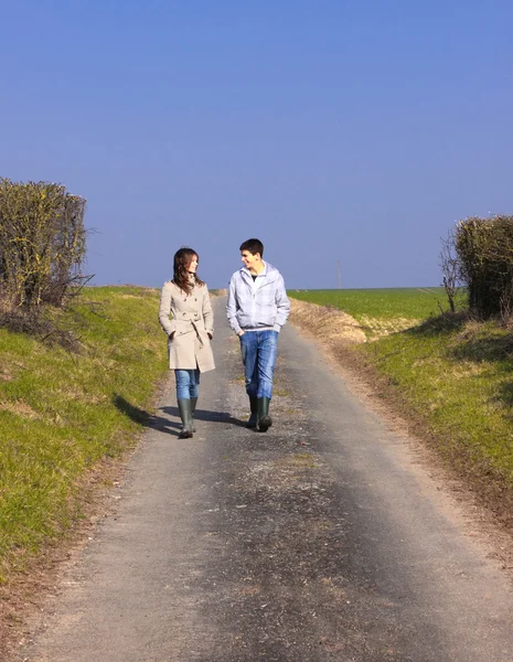 stock image Couple of young walking in the campaign in spring