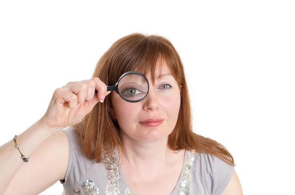 stock image Woman looks through a magnifier