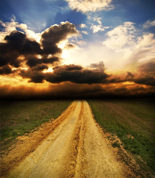 Sunset over dirty road — Stock Photo, Image