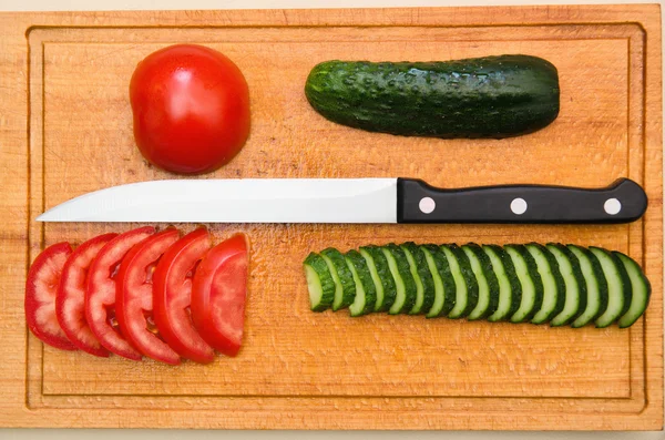 stock image Red tomato and green cucumbers