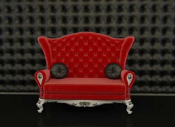 Sofá vermelho em um fundo preto — Fotografia de Stock