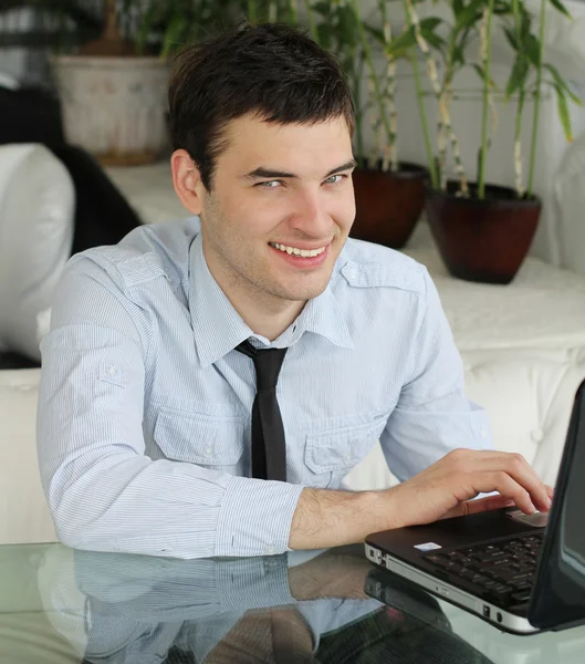 Handsome young men with laptop in public space. businessman smi — Stock Photo, Image