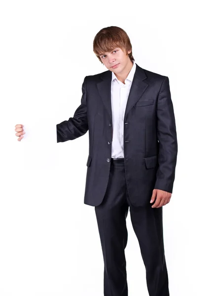 Portret van een glimlachende jonge zakenman die houdt van een leeg reclamebord, hand — Stockfoto