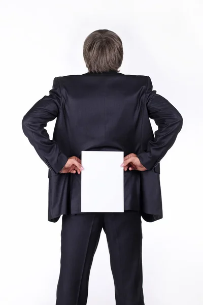 Businessman holding a blank white board on his back — Stock Photo, Image