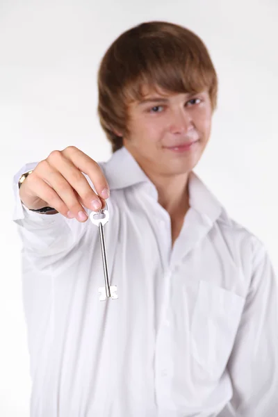 Happy young man with keys in hand — Stock Photo, Image