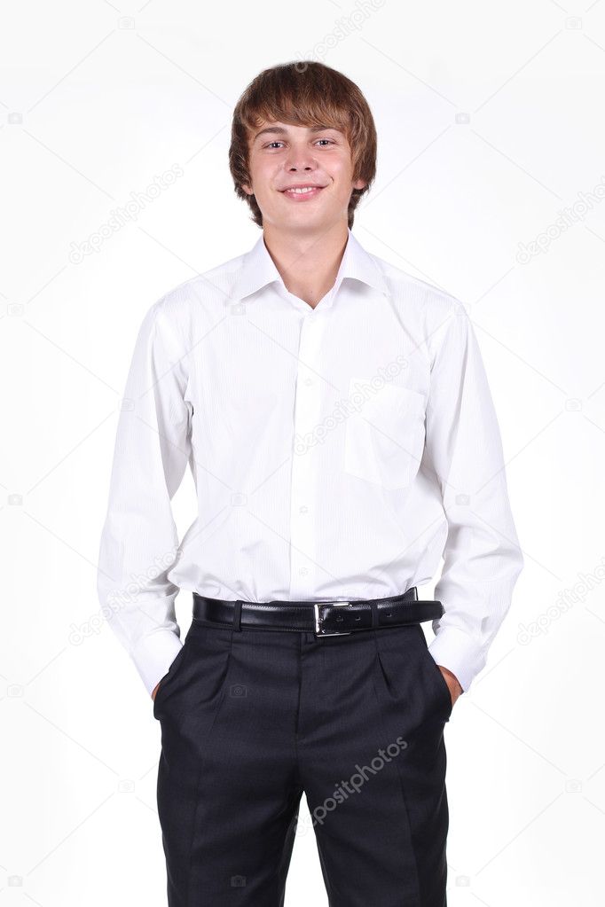 Portrait of a stylish young man standing with hands in pockets o