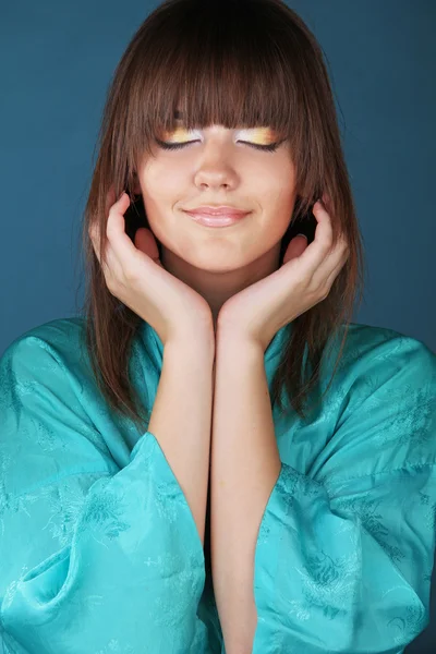 Vacker flicka i gröna orientaliska mantel lyssna musik — Stockfoto
