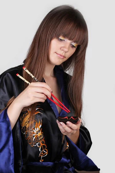 Geisha japonesa con palillos rojos —  Fotos de Stock