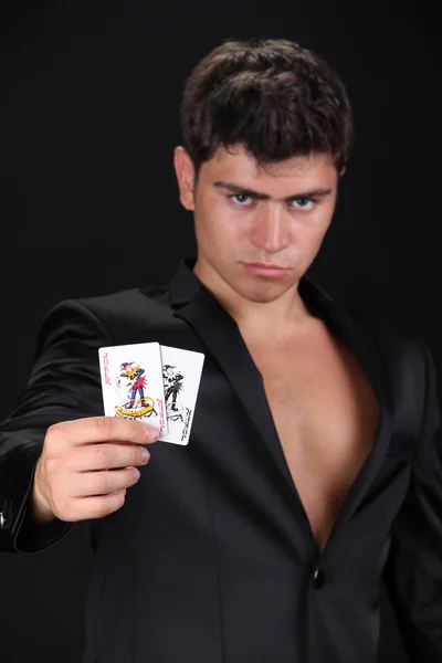 Cool young man holding four aces, shuffle the cards — Stock Photo, Image