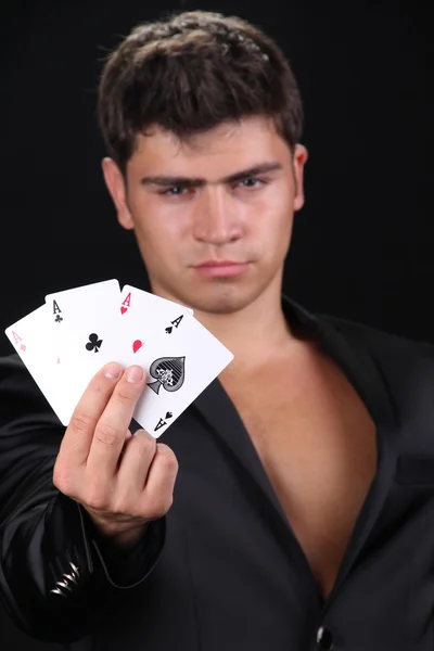stock image Cool young man holding four aces, shuffle the cards