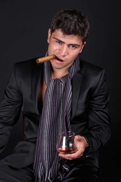 Handsome man holding cigar with smoke — Stock Photo, Image