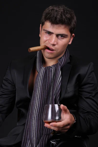 Handsome man holding cigar with smoke — Stock Photo, Image