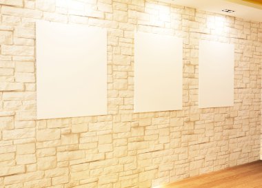 Empty frames on bricks wall in Gallery Interior clipart