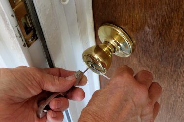 A Locksmith Picking A Lock clipart