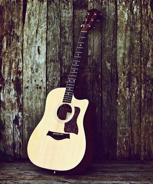 stock image Acoustic guitar on wood.