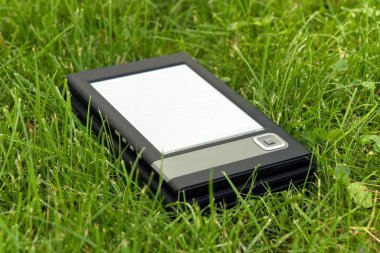 E-Book Reader in the grass clipart