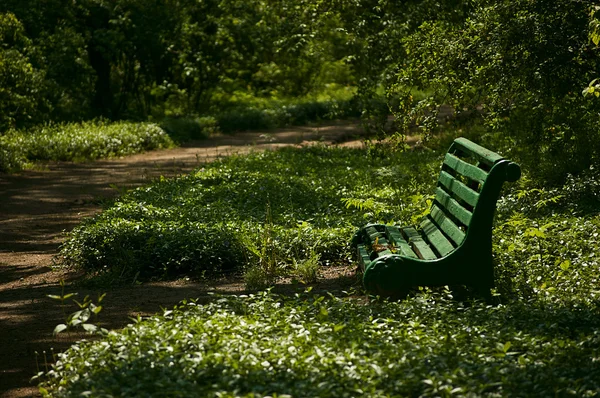 stock image Green bench in spring park