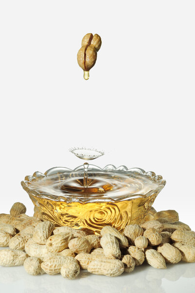 Flow out of the peanut oil, isolated on a white background.