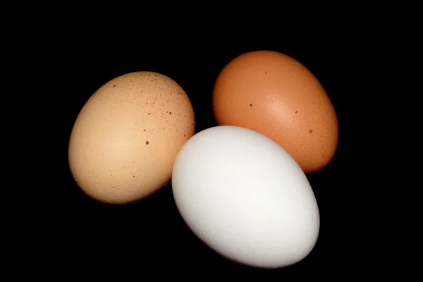 Three eggs on black — Stock Photo, Image