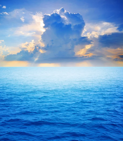 stock image A dramatic sky with raining clouds over the sea