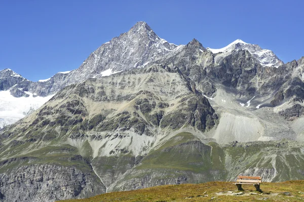 Bänk med utsikt över de vackra bergen — Stockfoto