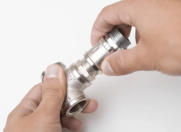 Connectors of plumbing pipes in the hands — Stock Photo, Image