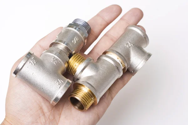 Connectors of plumbing pipes in the hand — Stock Photo, Image