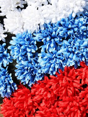 Three coloures of flag: white, blue, red, made from flowers clipart
