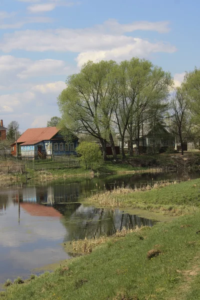 stock image Wooden cottages near lake