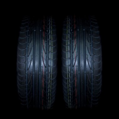 Car tire on black background clipart