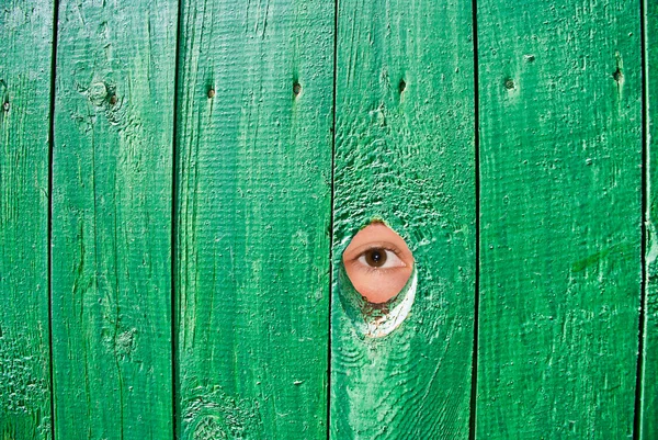 stock image Eye in a hole in fence