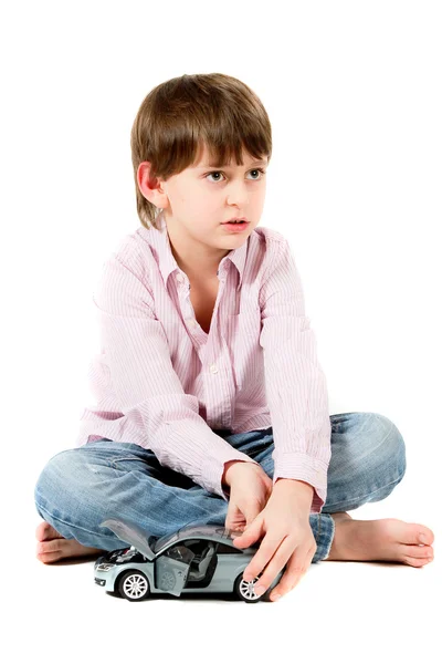 Little boy sitting on the floor and playing machine — Stock Photo, Image