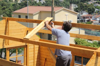 Workers building a roof clipart