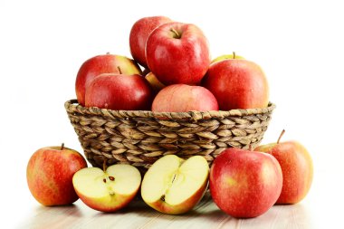 Apples and wicker basket isolated on white clipart