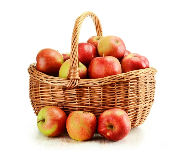Manzanas y canasta de mimbre aisladas en blanco — Foto de Stock