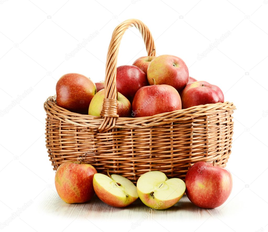 Apples and wicker basket isolated on white