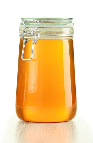 Large jar of honey isolated on white Royalty Free Stock Images