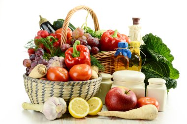 Raw vegetables and wicker baskets isolated on white clipart