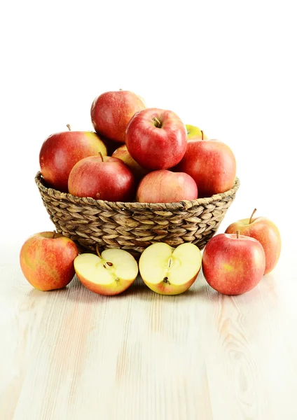 Apples and wicker basket — Stock Photo, Image