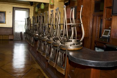 Bar stools stacked on the bar clipart