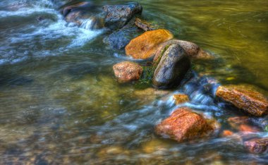 Rocks and rolling river in hdr clipart