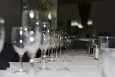 Wedding reception dinner table glasses lined up. clipart