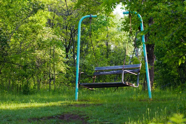 A swinging bench in the woods — Stock Photo, Image