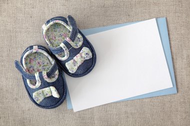 Baby shoes and blank note clipart