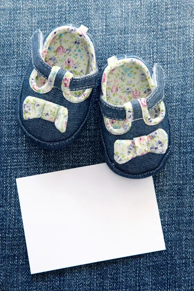 Sapatos de bebê e nota em branco — Fotografia de Stock