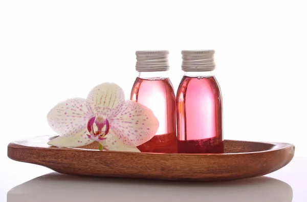 Bottles with essential oils and orchid — Stock Photo, Image