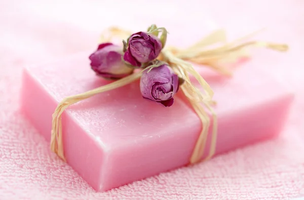 Pink soap with dried roses — Stock Photo, Image
