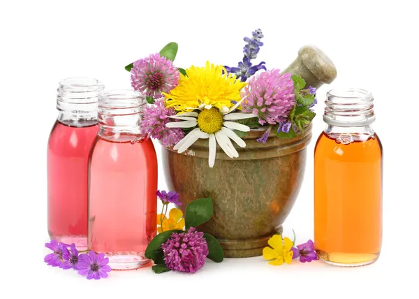 Mortar with fresh flowers and essential oil — Stock Photo, Image