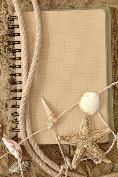 Exercise book and seashell — Stock Photo, Image